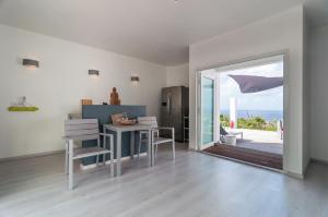 a living room with a table and chairs and a sliding glass door at Bonaire Bay View Villa in Kralendijk