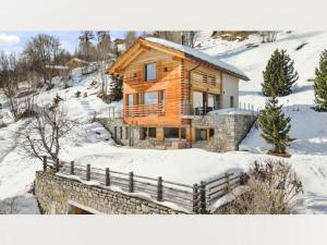 a log cabin in the snow with a fence at Apartment in Sankt Moritz in St. Moritz
