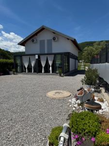 a house with a gravel driveway in front of it at AM Una Lux House in Bihać