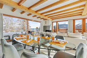 a dining room with a glass table and chairs at Apartment in Sankt Moritz in St. Moritz