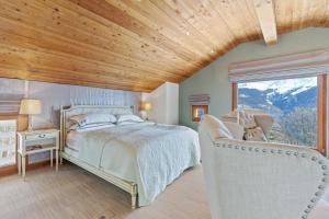 a bedroom with a bed and a chair and a window at Apartment in Sankt Moritz in St. Moritz