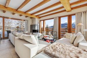 a living room with white furniture and large windows at Apartment in Sankt Moritz in St. Moritz
