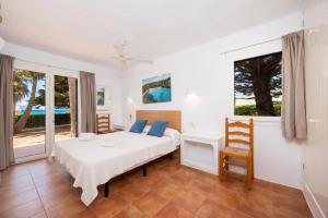 a bedroom with a bed and a view of the ocean at Villa Binipaco in Binibeca +24 photos