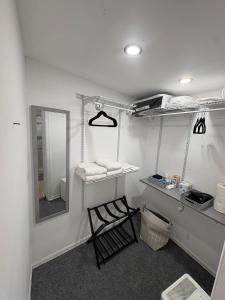 a bathroom with a mirror and a shelf with towels at Couples Retreat in Nazareth
