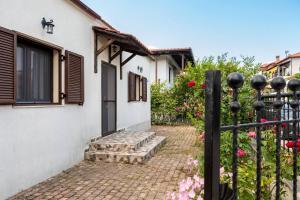a house with a gate and a brick walkway at Bella Garden House in Ierissos
