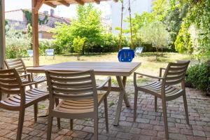 a wooden table with four chairs around it at Bella Garden House in Ierissos