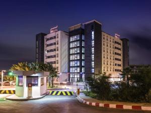 a hotel at night with two tall buildings at ibis Oran les Falaises in Oran