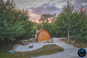 a small wooden cabin in the middle of a forest at The Cranny at Kimberly Creek Retreat in Ashland