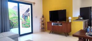 ein Wohnzimmer mit einem Flachbildfernseher auf einem Schrank in der Unterkunft Valentina Holbox by Las Flores Vacation Rentals in Holbox + 40 Fotos
