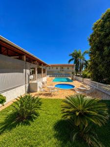 a house with two swimming pools in a yard at Pousada Mais Cacau in Itu