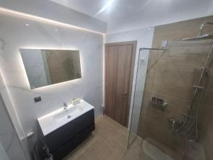 a bathroom with a sink and a shower at Hanna's Villagio in Korinthos +32 photos