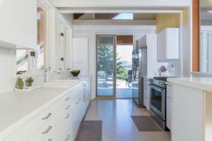 a kitchen with white cabinets and a large doorway at Mountain Mid Century in Sun Valley
