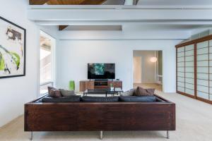 a living room with a couch and a tv at Mountain Mid Century in Sun Valley