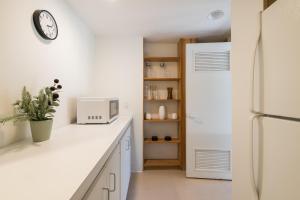 a kitchen with a refrigerator and a white counter top at Mountain Mid Century in Sun Valley