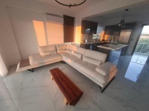 a living room with a couch and a table at Hanna's Villagio in Korinthos