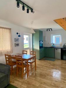 a kitchen and dining room with a table and chairs at Domek Adam in Macharce