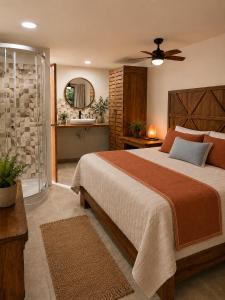 a bedroom with a large bed and a bathroom at Sanctuary Puerto Viejo in Cocles +66 photos