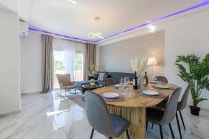 a dining room with a wooden table and chairs at Casa Eda in Agia Marina Nea Kydonias