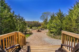 a wooden bridge over a dirt road with trees at The Cranny at Kimberly Creek Retreat in Ashland