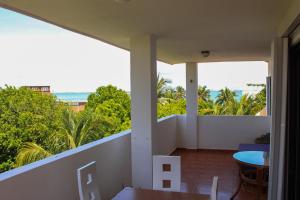a balcony with a table and a view of the ocean at Suites Marea in Cancún