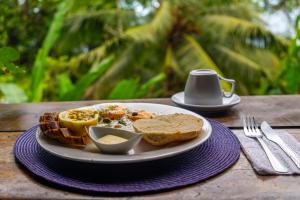 a plate of food with toast and bread and a cup of coffee at Pure Roots in Bastimentos +45 photos
