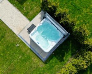 an aerial view of a bath tub in the grass at Villa Aurelia Spa, Zeewolde 52 in Zeewolde