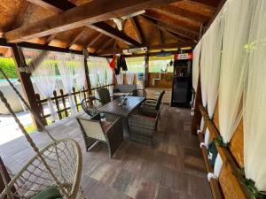 a patio with a table and chairs on a porch at AM Una Lux House in Bihać
