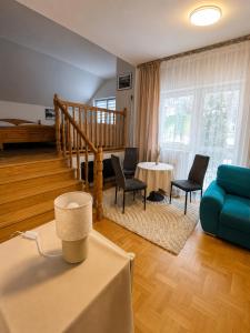 a living room with a blue couch and chairs at Amphora Kompleks Wypoczynkowy in Krynica Zdrój