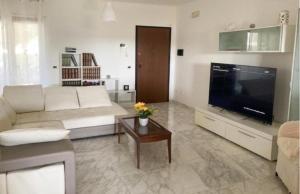 a living room with a couch and a television at Casa Ulivo in Pulsano
