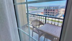 a balcony with a table and a view of a building at Grand Stylish Two bedrooms Apartment in El Alamein +12 photos