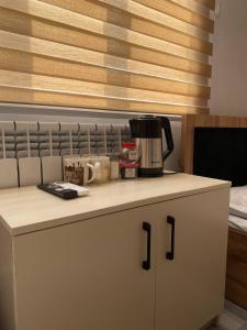 a kitchen counter with a coffee maker on top of it at Pure Hostel in Tashkent