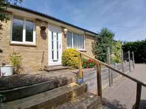 a house with stairs leading to the front door at Marley Farm Bungalow in Deal