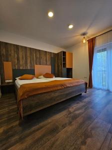 a bedroom with a large bed in a room at Apartments and Rooms Villa Majestic in Bihać