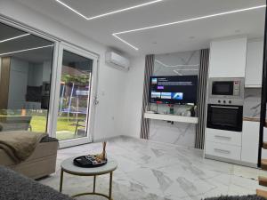 a living room with a couch and a table and a tv at Oaza mira 2 in Jajce +17 photos