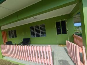 a room with chairs and a green wall at LG Palms in Sigatoka