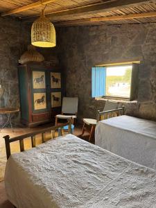 a bedroom with two beds and a window at Casa Paz by Otium in La Cruz