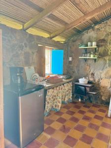 a kitchen with a counter in a stone kitchen at Casa Paz by Otium in La Cruz