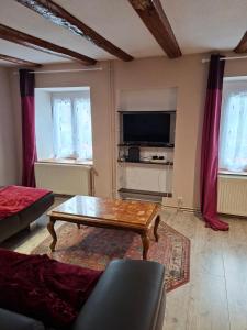 a living room with a couch and a coffee table at La Maison du Cordonnier in Fréland
