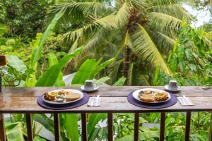 a table with two plates of food on it at Pure Roots in Bastimentos