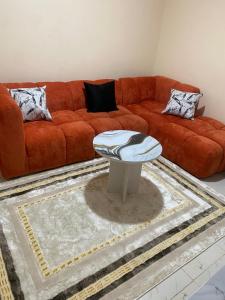 a living room with a couch and a table at Banas Homes Kakamega in Kakamega