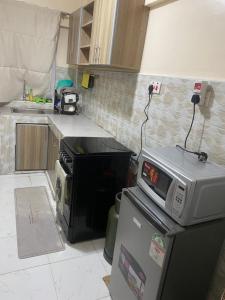 a kitchen with a microwave on top of a refrigerator at Banas Homes Kakamega in Kakamega