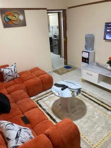 a living room with a couch and a table at Banas Homes Kakamega in Kakamega
