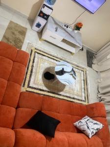 a couch in a living room with a painting on the wall at Banas Homes Kakamega in Kakamega