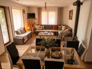 a living room with a couch and a table at Hotel Chalet Kujta in Peje