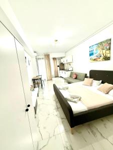 a bedroom with a bed and a living room at Serene Studios in Eforie Nord