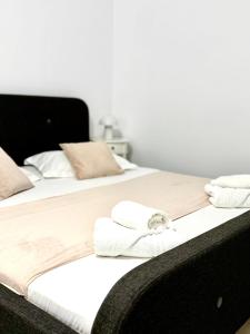 two beds with towels on them in a bedroom at Serene Studios in Eforie Nord