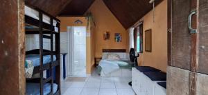 a room with a bedroom with a bed in it at Chalés Recanto da Aldeia in Itanhaém