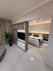 a bedroom with a bed and a tv in it at Agulhon Hotel in Primavera do Leste +66 photos