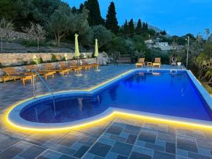 a swimming pool with lights in a resort at Ranc Mujica in Bar
