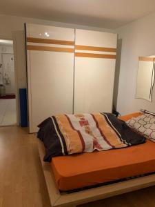 a bedroom with a bed with an orange bed frame at Winterthur in Winterthur